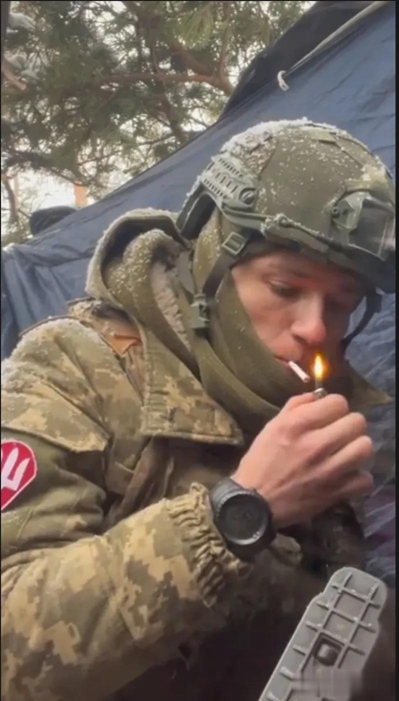 乌军视频，一名乌军士兵躲在堑壕内无聊，被俄军狙击手盯上，刚掏出烟准备点火，忽然听