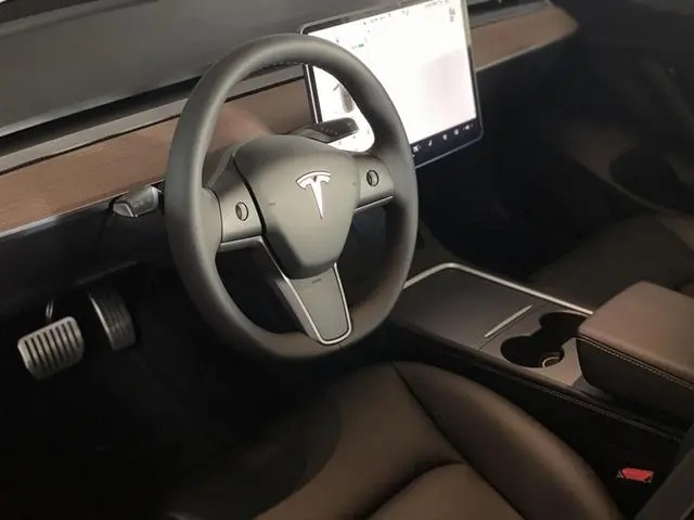 特斯拉Model 3的内饰经常被调侃为“毛坯房”，里面比较引人注目的装饰就是横跨
