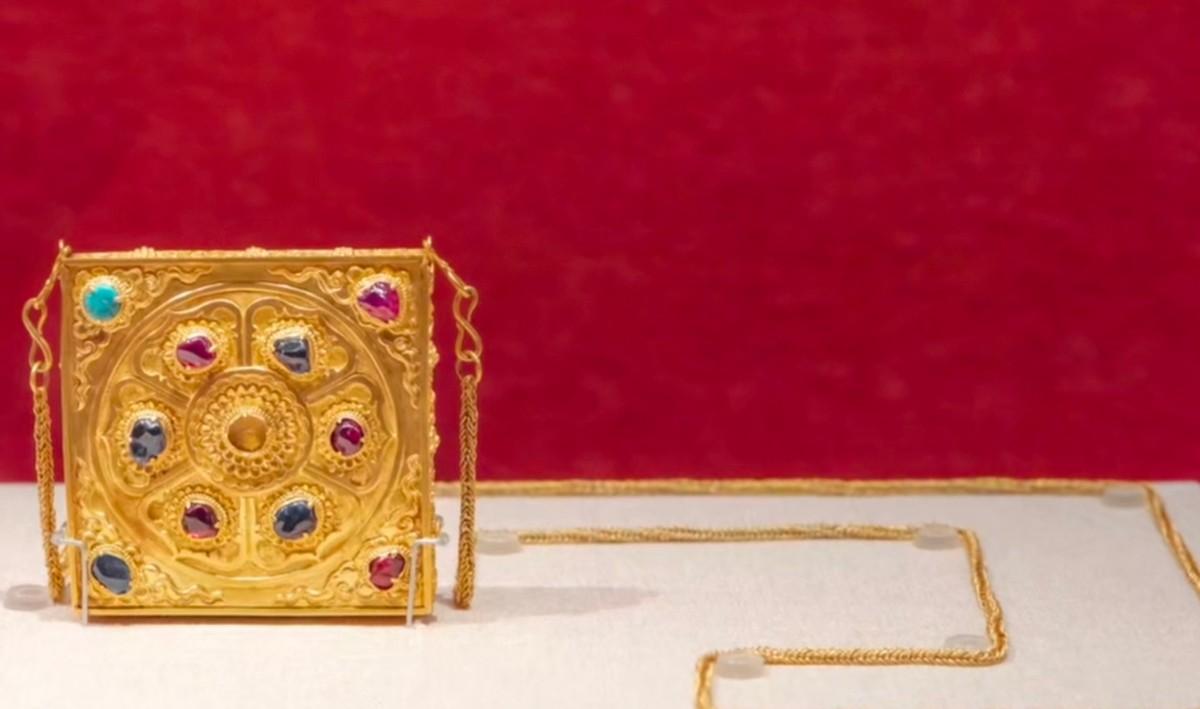 不少现代女孩“包”治百病，明朝贵妇梅妙灯也有一款方形链条包。这款包上面点缀着金光