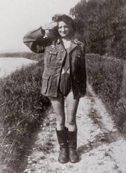 1942年夏天，法国南部，一名身披德国军服内穿泳装的年轻女子，用一种不自然的语气