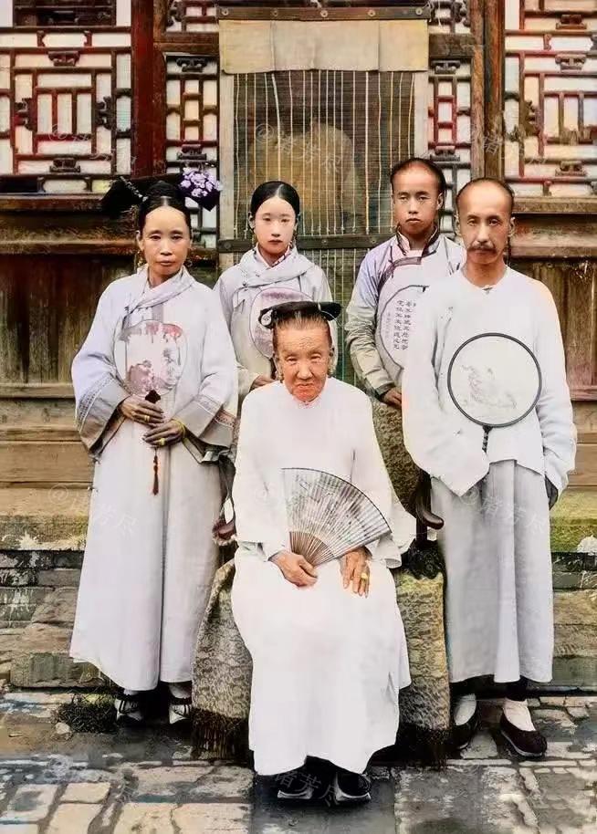 晚清时期，北京，一个满人家族中的祖孙三代留下了这张罕见合影。镜头中手拿折扇落座的