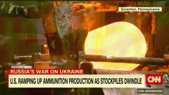 一名戴着眼镜的小黑哥正用一把特制的钩子将一个粗糙炮弹壳推到流水线上。美帝的宾夕法